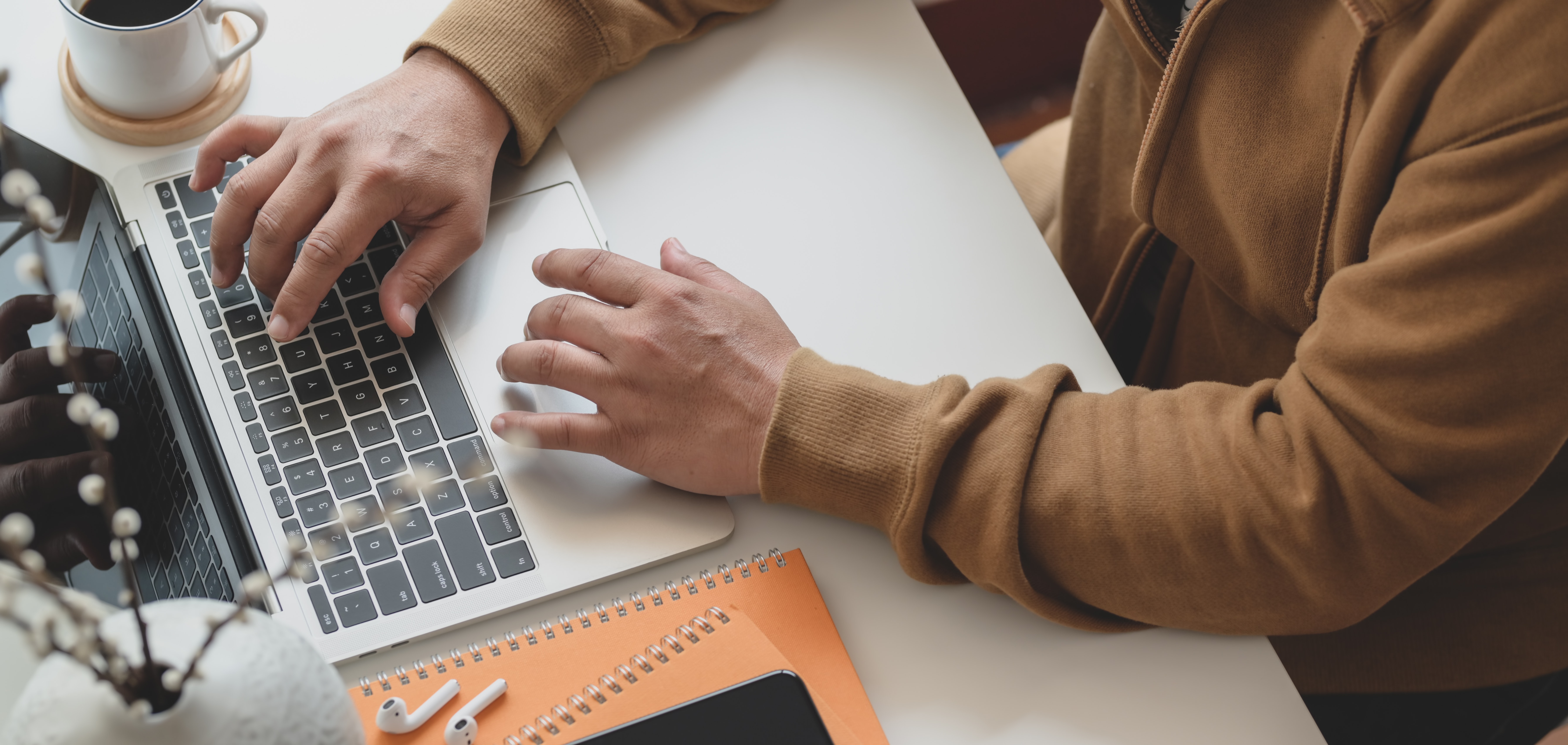 person-in-brown-long-sleeve-shirt-using-macbook-pro-3787311